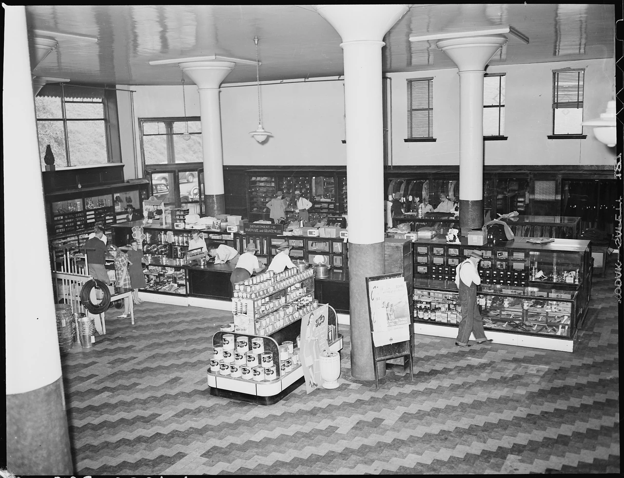 Archival black-and-white photograph of shoppers and counters inside a Lynch company store in 1946.